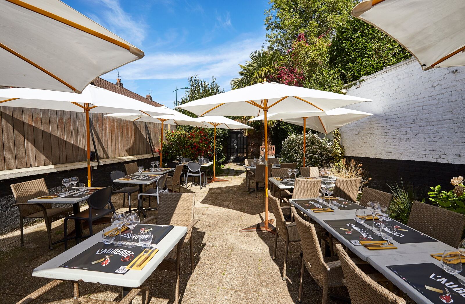 La terrasse de L'Auberge de Mouvaux sous les parasols blancs